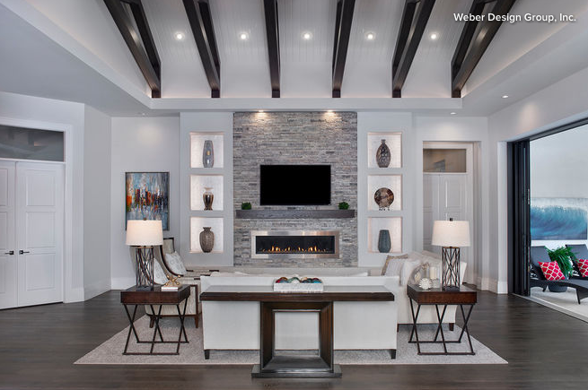 Large white and black living room with sofa table up against white sofa