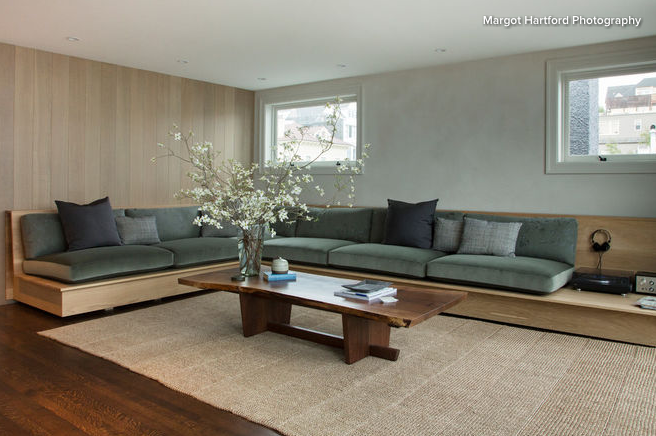 Contemporary low profile sectional with large wooden coffee table