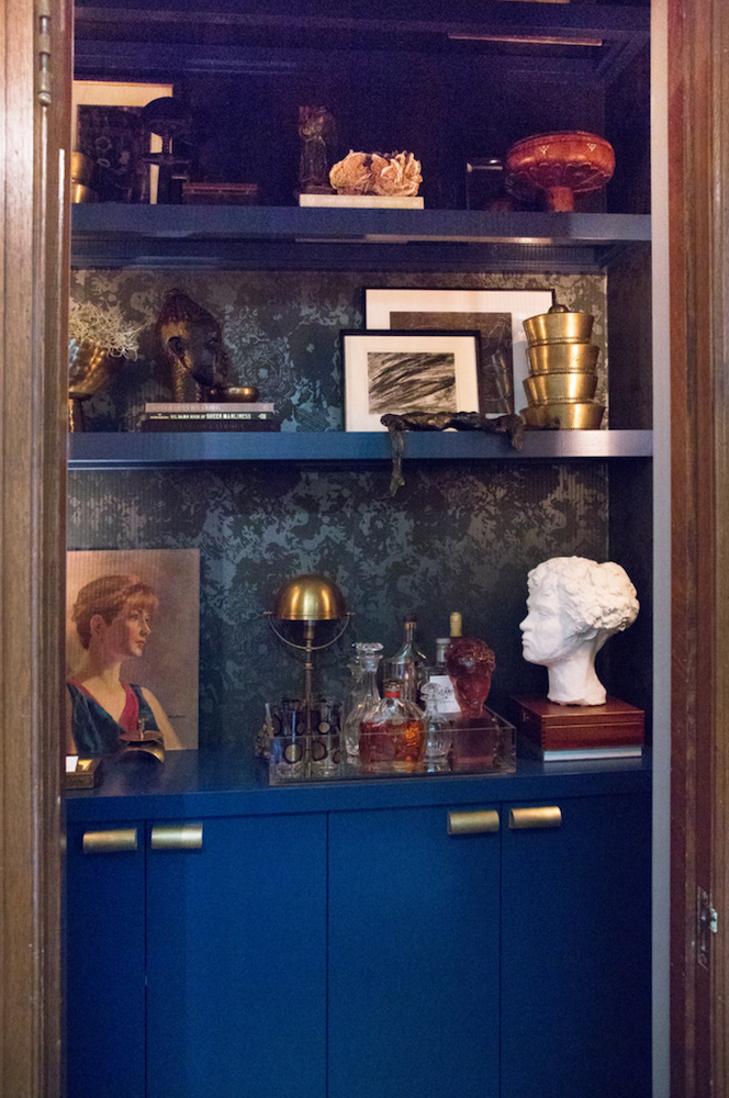 blue bookcase closet storage with pictures and accessories