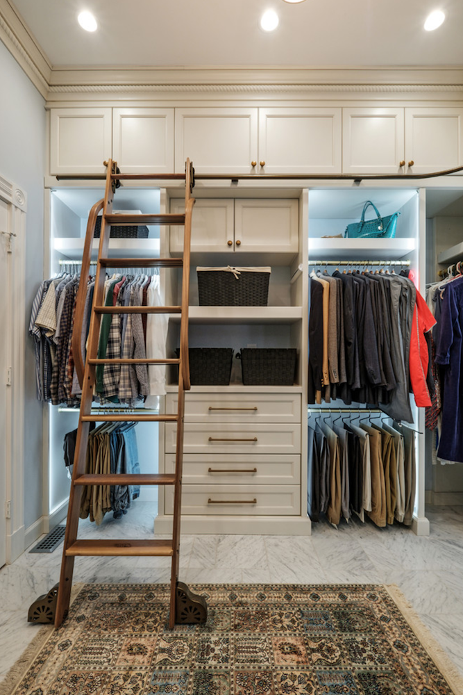 ladder up to top shelves in large white closet