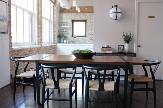 wood dining table with four black chairs