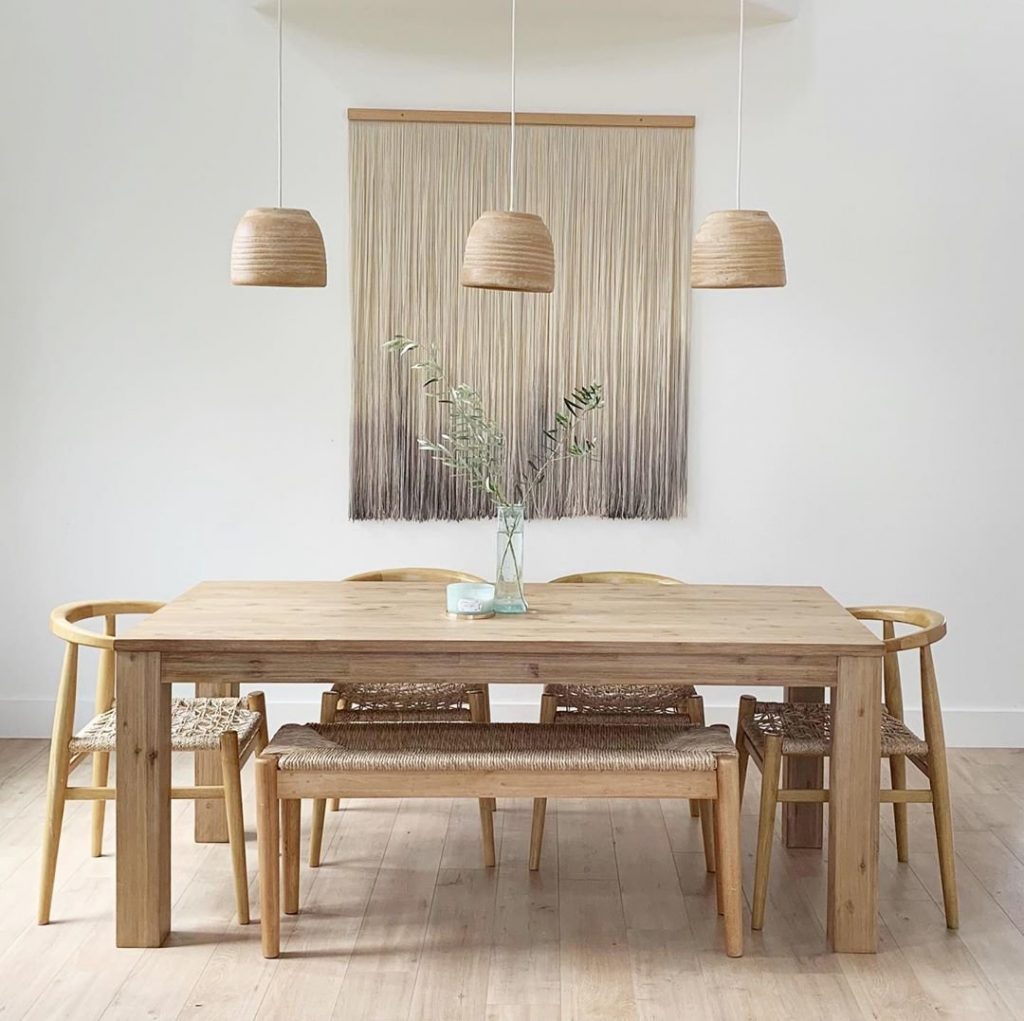 wooden table, chairs, lights and wall art