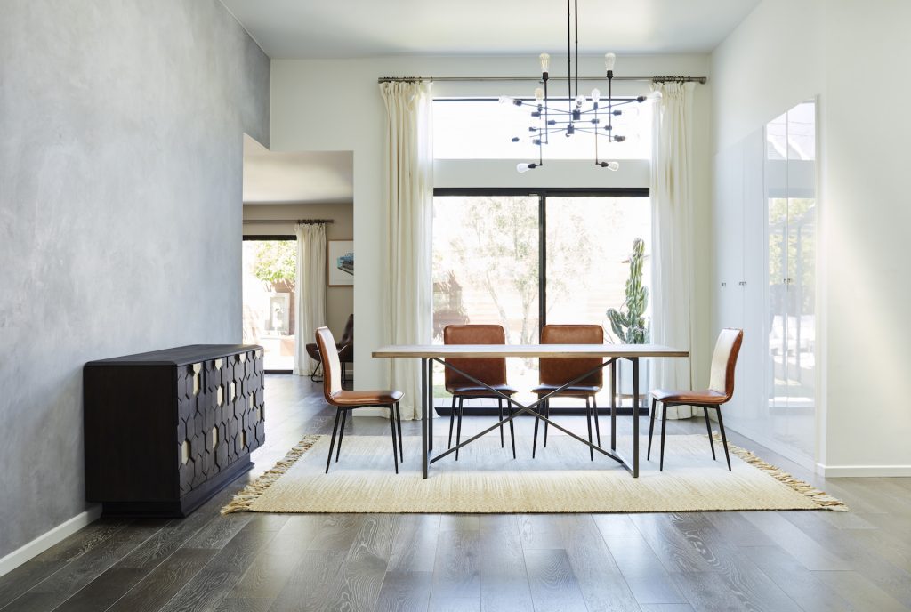 clean white room with curtains and a rug, cabinet, table, chairs