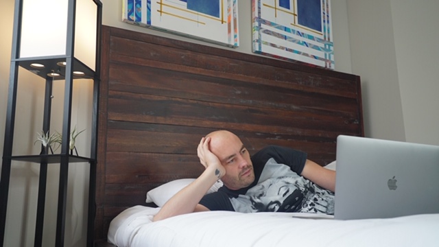 man in bed with a laptop