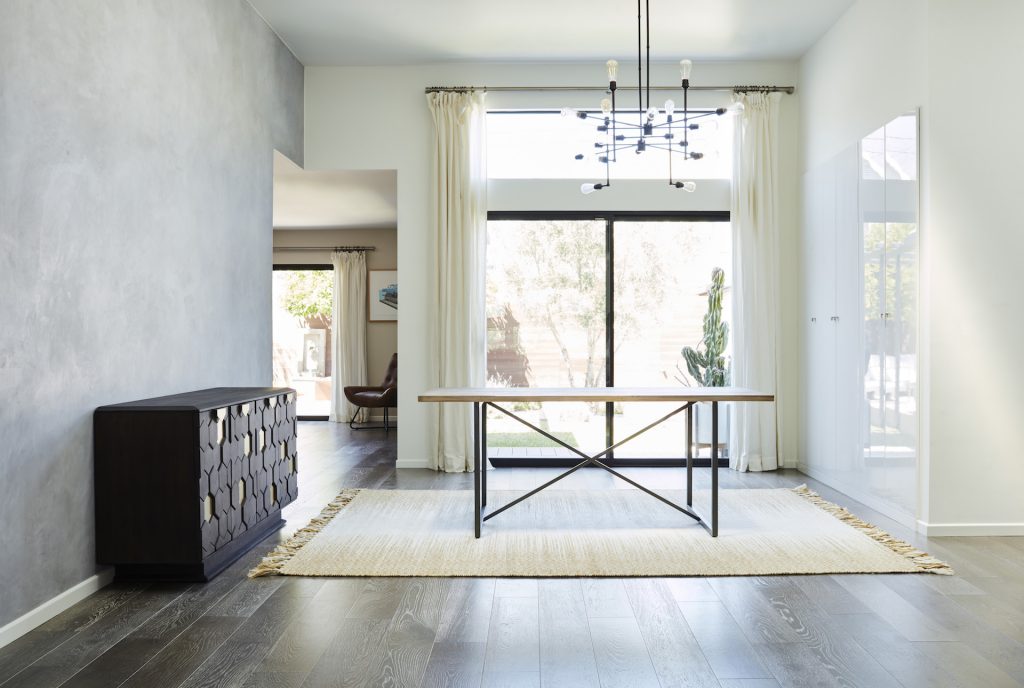 clean white room with curtains and a rug, cabinet, table