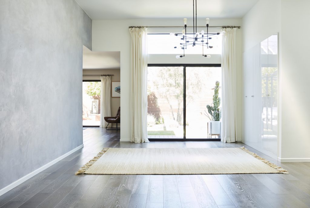 clean white room with curtains and a rug