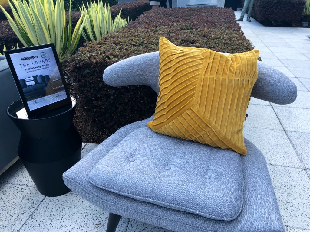 grey chair with yellow pillow