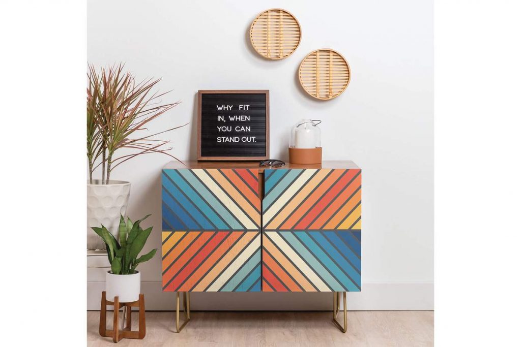 colorful cabinet with a picture, light, wall art and plants