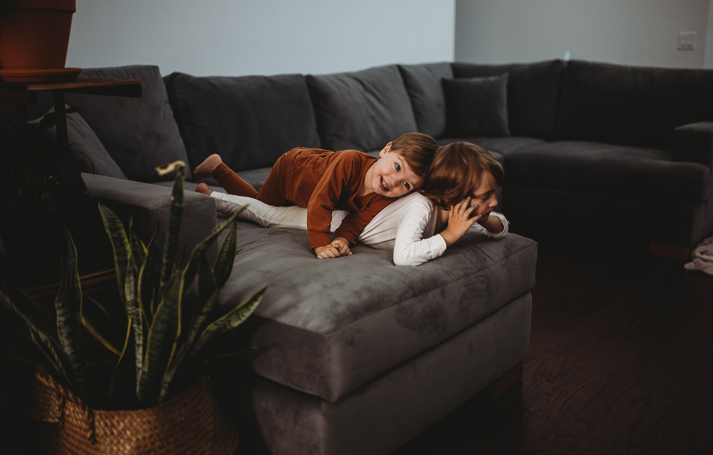 two children on grey sofa