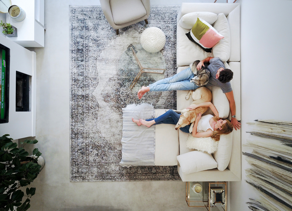 white sofa with two people and two dogs