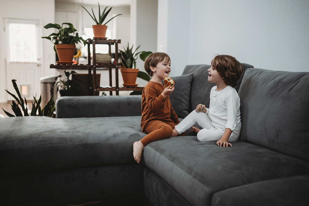 two children on a grey sofa