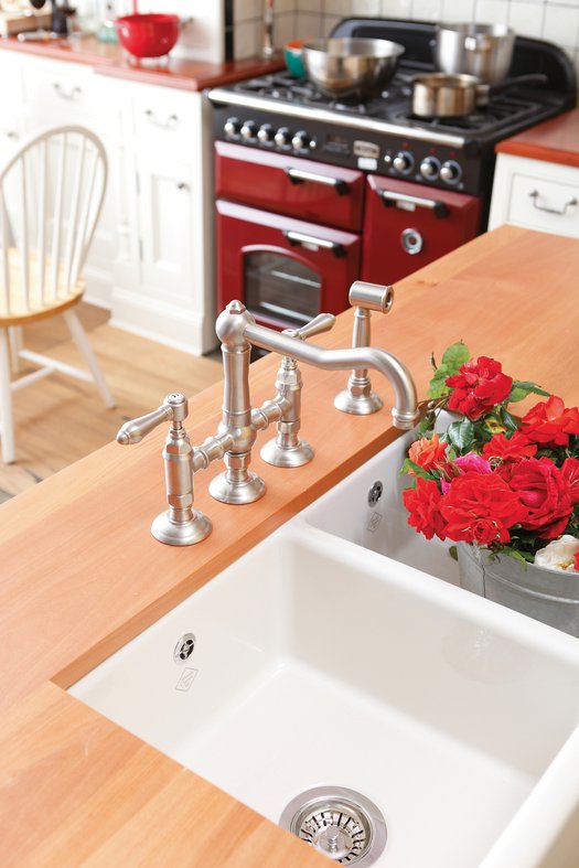 Bridge mixer with hand shower in rural kitchen