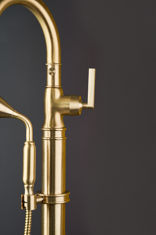 Detail of a freestanding bath tap in a contemporary bathroom