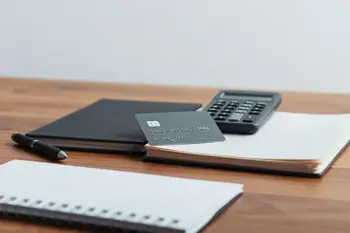 A close-up of a generic credit card placed on a desk, representing financial management and credit education.