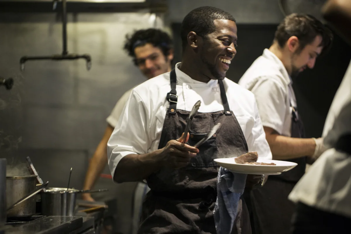 Chef_in_Kitchen_Smiling__1__bvi2fh