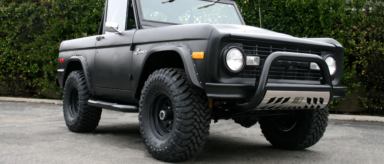 Black 1975 Ford Bronco with ARIES 3-inch round side bars and bull bar