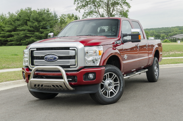 Red Ford F350 with ARIES 4-inch oval side bars and bull bar