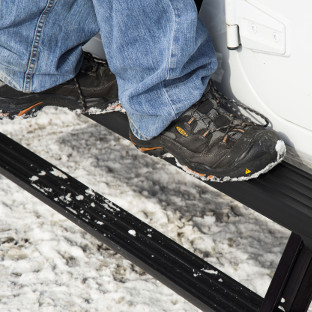 ActionTrac™ running boards two-step access on a Jeep Wrangler JK in the snow