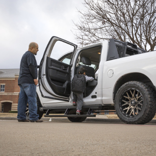 White Ram 1500 with ActionTrac™ running boards - father and son