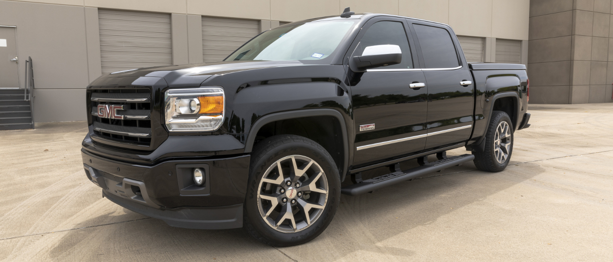 Black 2015 GMC Sierra 1500 with ARIES AscentStep® running boards