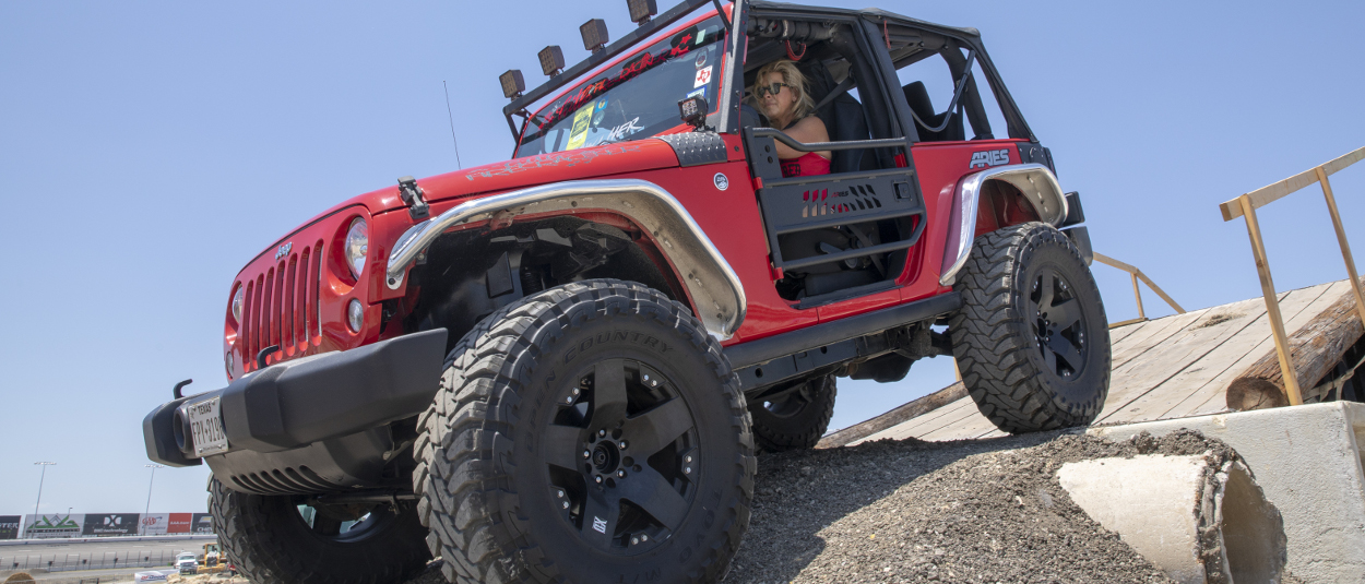 Red 2015 Jeep Wrangler JK with ARIES Jeep fender flares in raw aluminum