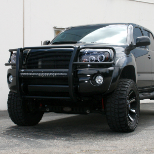 Custom black 2013 Toyota Tacoma with ARIES Pro Series grille guard