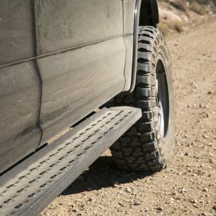 ARIES RidgeStep running boards on dirty offroad truck