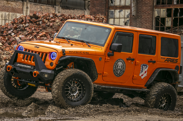 Orange custom 2013 Jeep Wrangler JK Unlimited with ARIES Rocker Steps and Jeep accessories