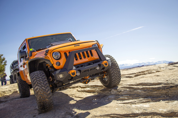 Orange 2013 Jeep Wrangler JK Unlimited rock crawler with ARIES TrailChaser® bumper