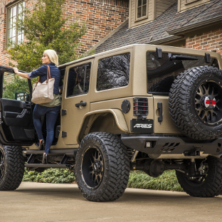 Tan 2017 Jeep Wrangler JK Unlimited with ARIES TrailChaser® rear bumper and Jeep accessories