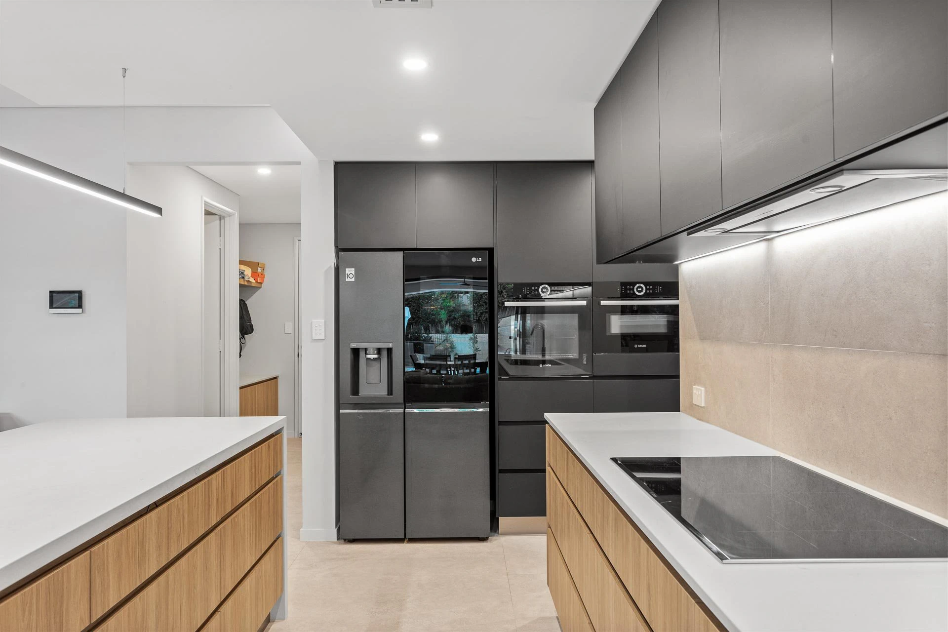 Modern kitchen with black appliances and wooden storage cabinets