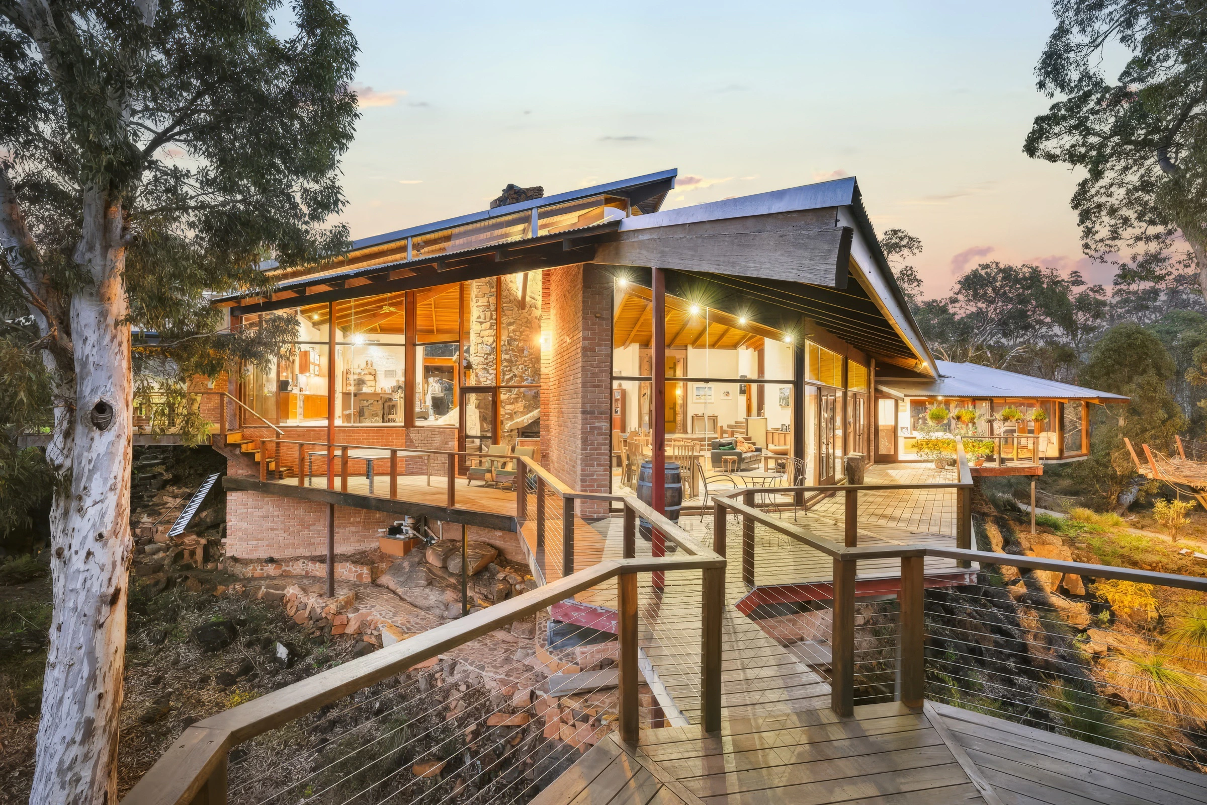 Luxury glass-view cliffside house with wooden balcony and modern interior design