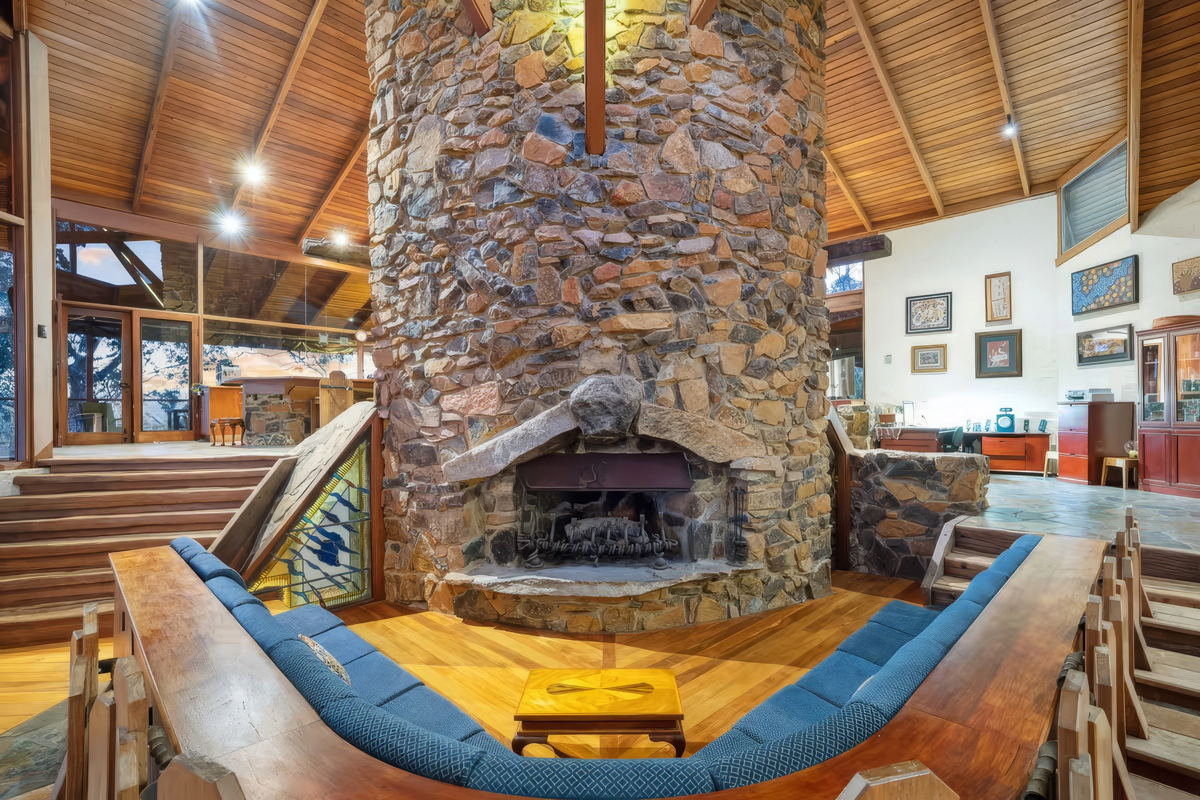 The soaring stone fireplace lies at the heart of the home