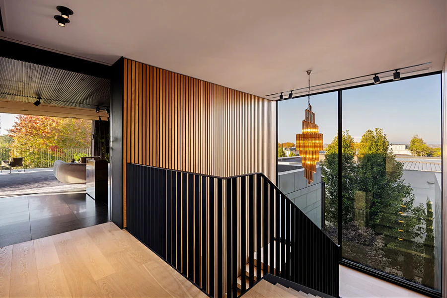 Staircase landing featuring floor-to-ceiling windows
