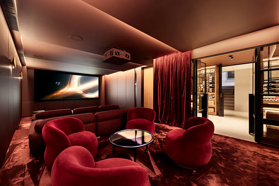 Luxury home theater room with red velvet seating