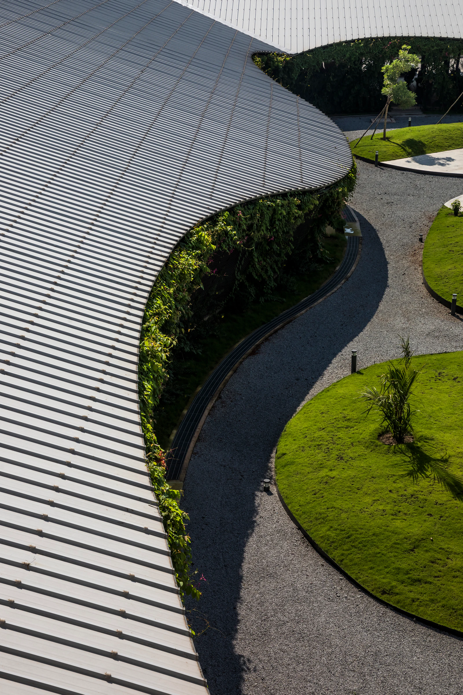 Jakob Factory corrugated roof, planted façade and gravel courtyard