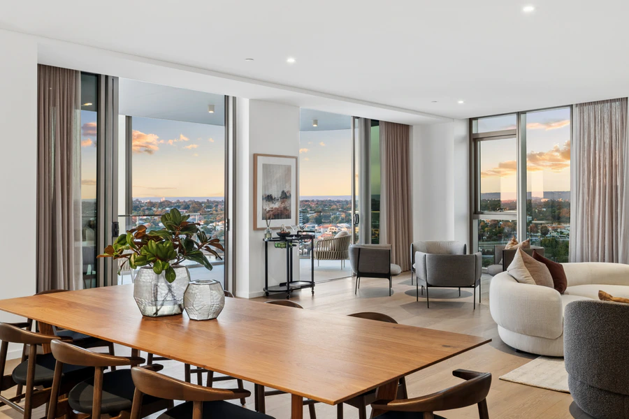 Open-plan living and dining area with indoor-outdoor connection to balcony