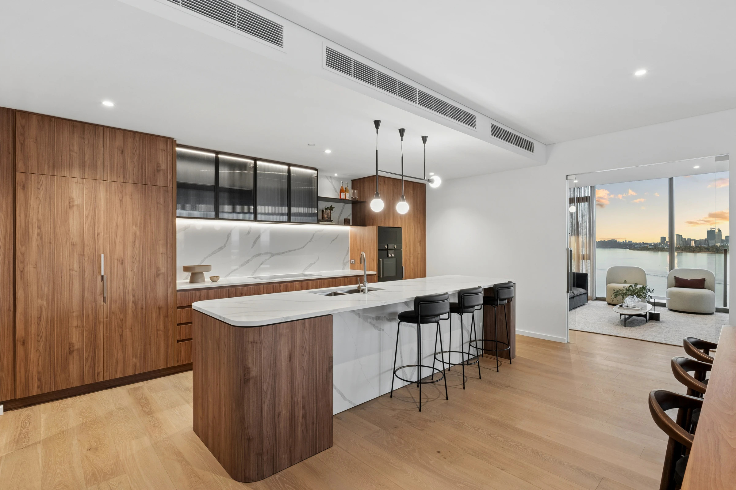 Spacious kitchen featuring custom timber-grain cabinetry and premium integrated Gaggenau appliances