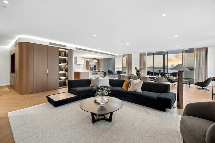 Open-plan living area with custom cabinetry and ample storage space
