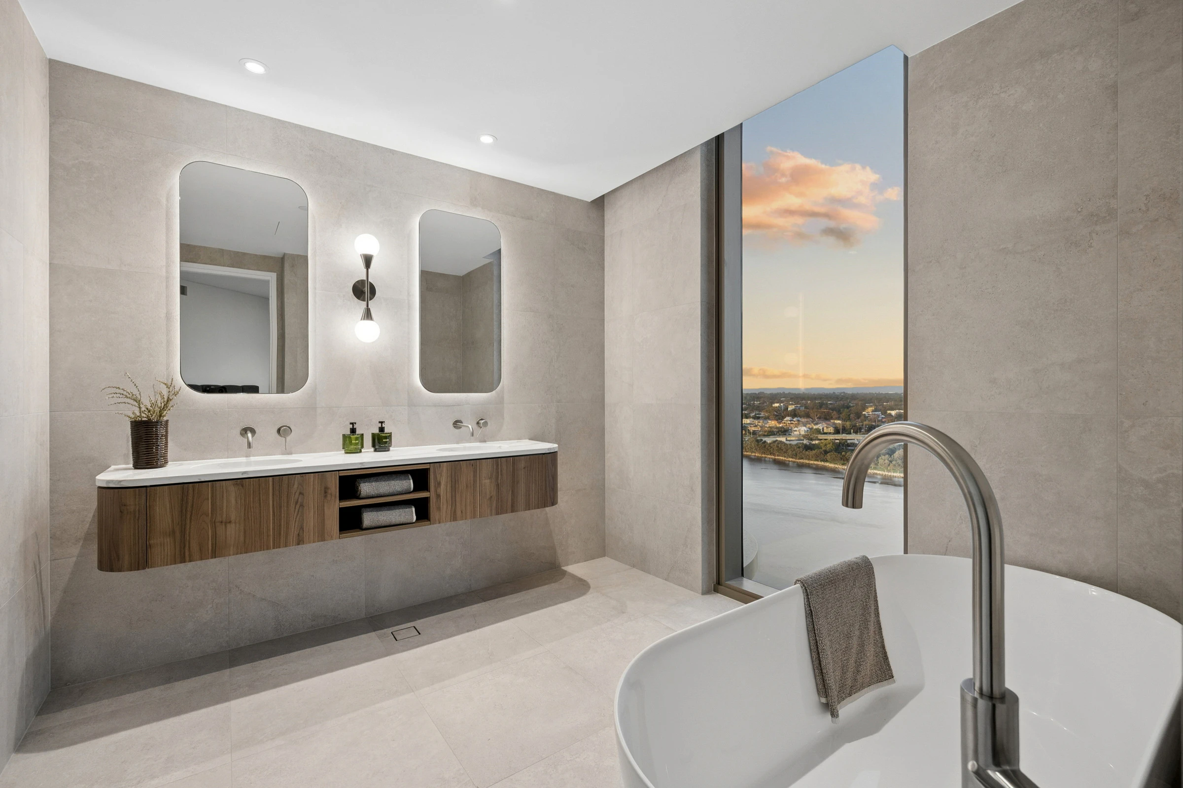 Spacious master ensuite with floating double vanity and freestanding bath