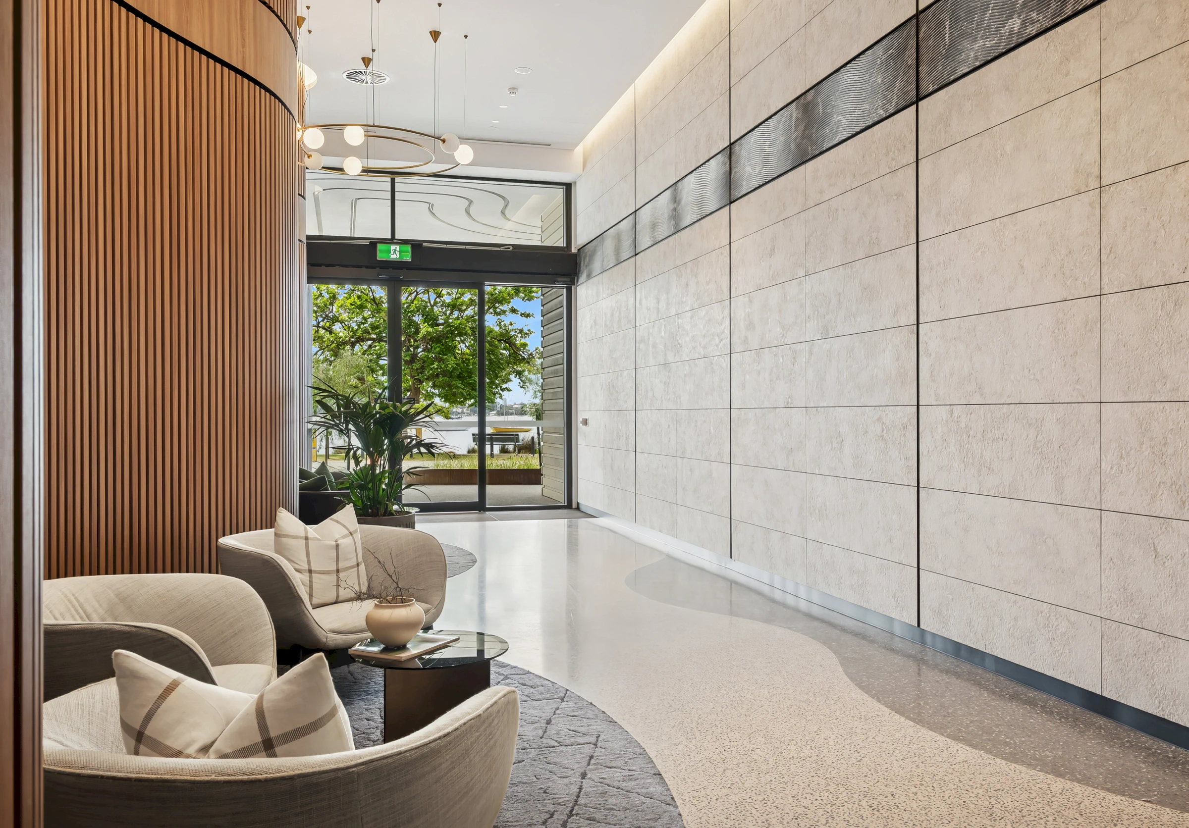 Rivière Residences lobby timber wall stone panels and river views