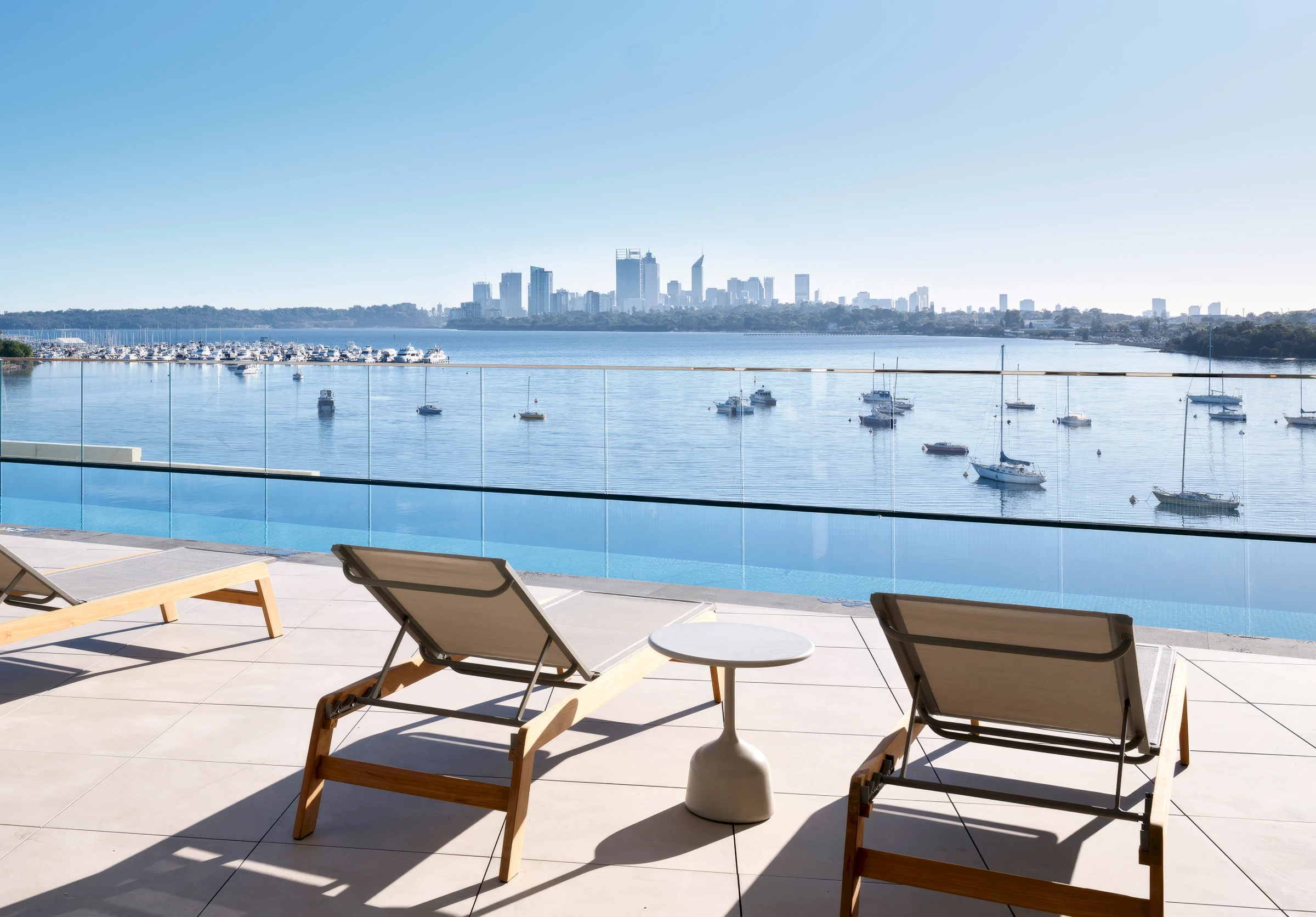 Furnished pool deck on the Level 3 podium offering panoramic views over the Swan River