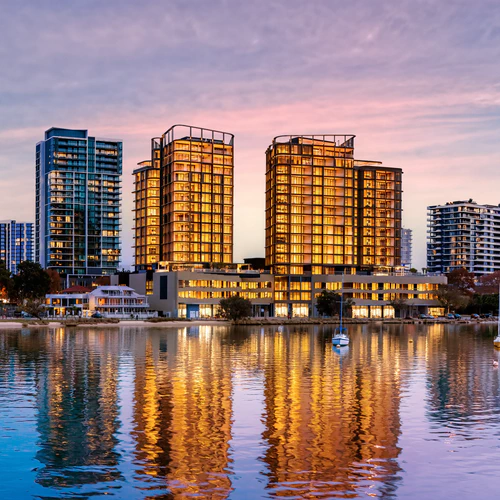 Rivière Residences towers on Swan River waterfront at dusk