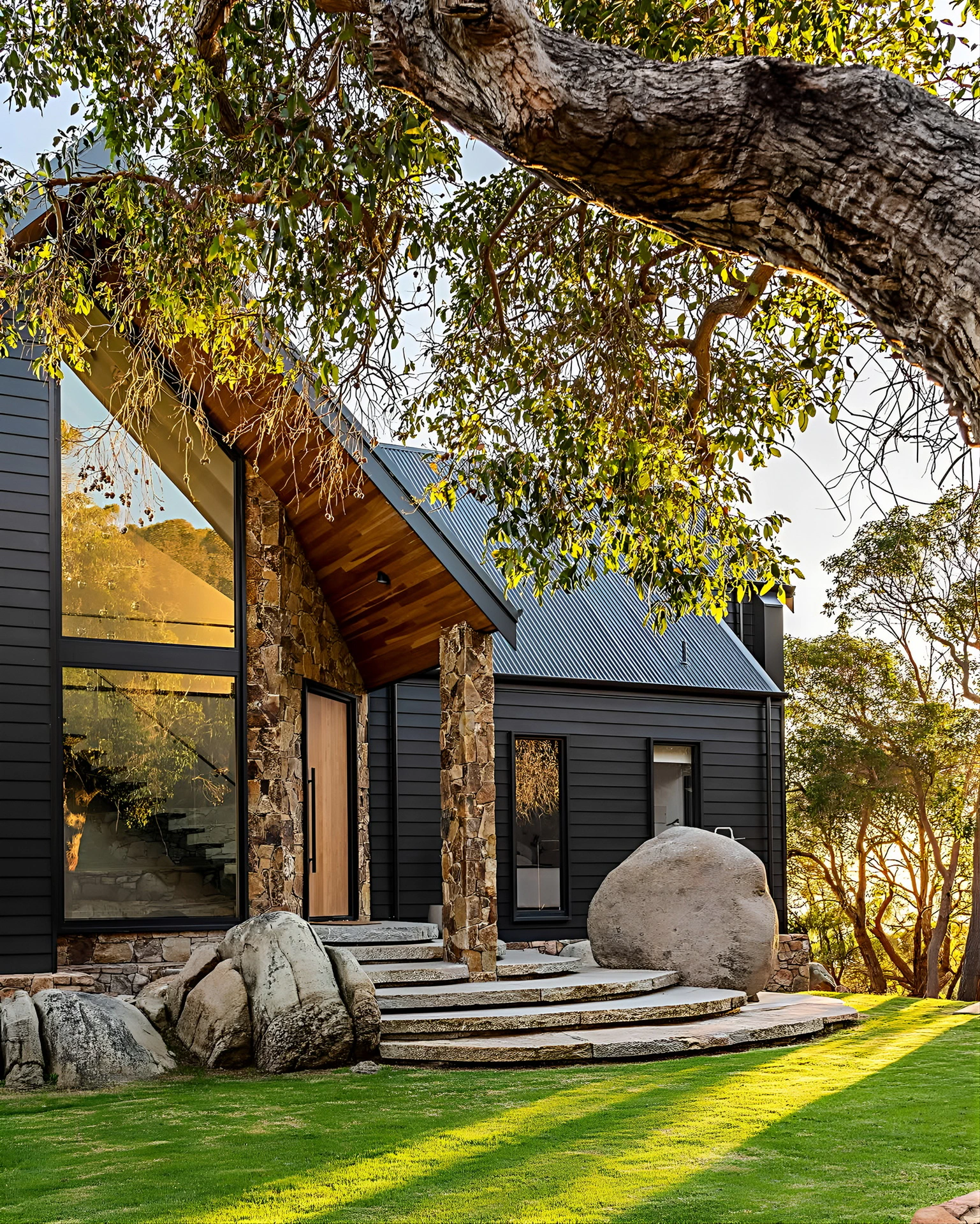 Contemporary house exterior featuring stone accents and natural landscaping