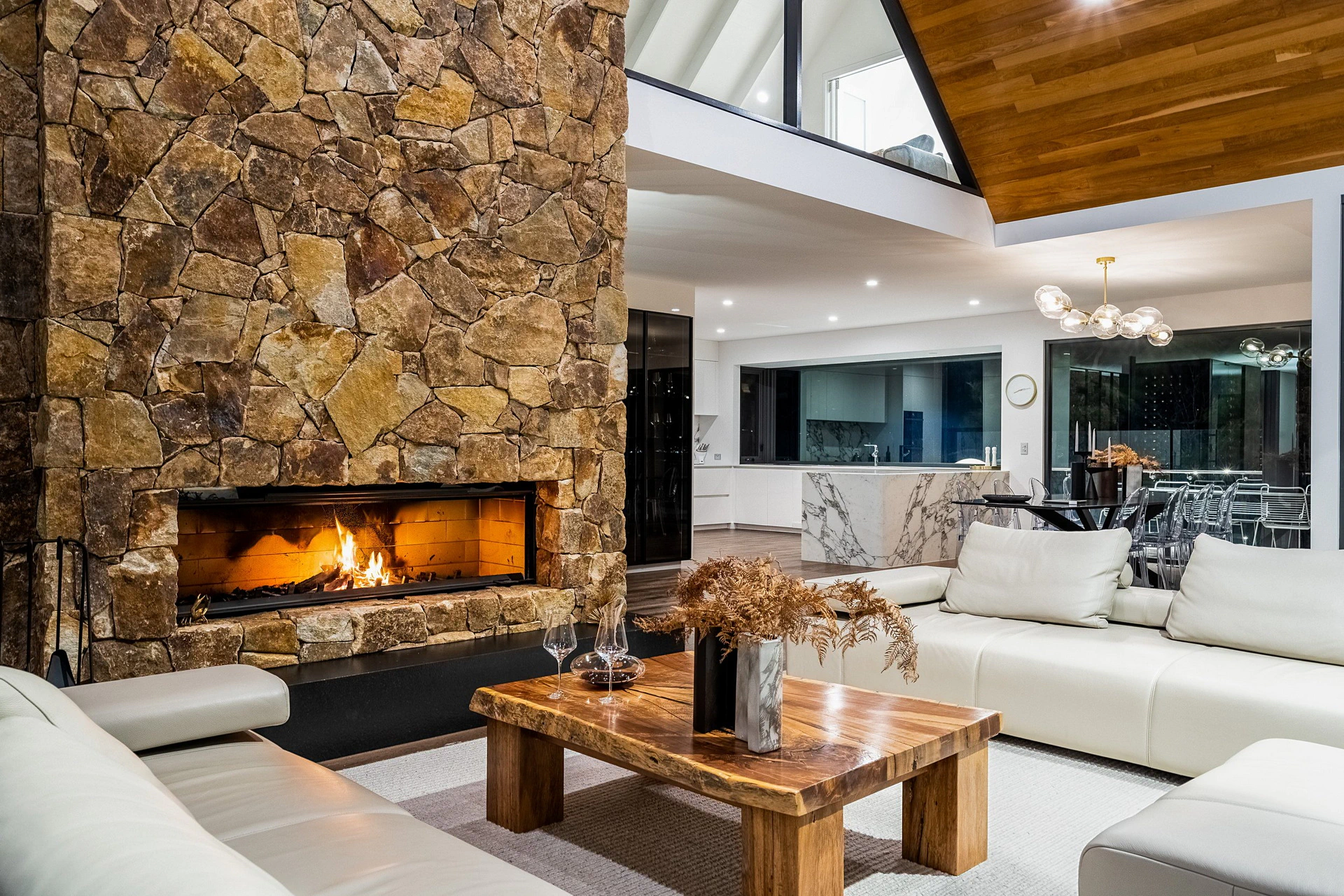 Contemporary living room interior featuring a stone fireplace