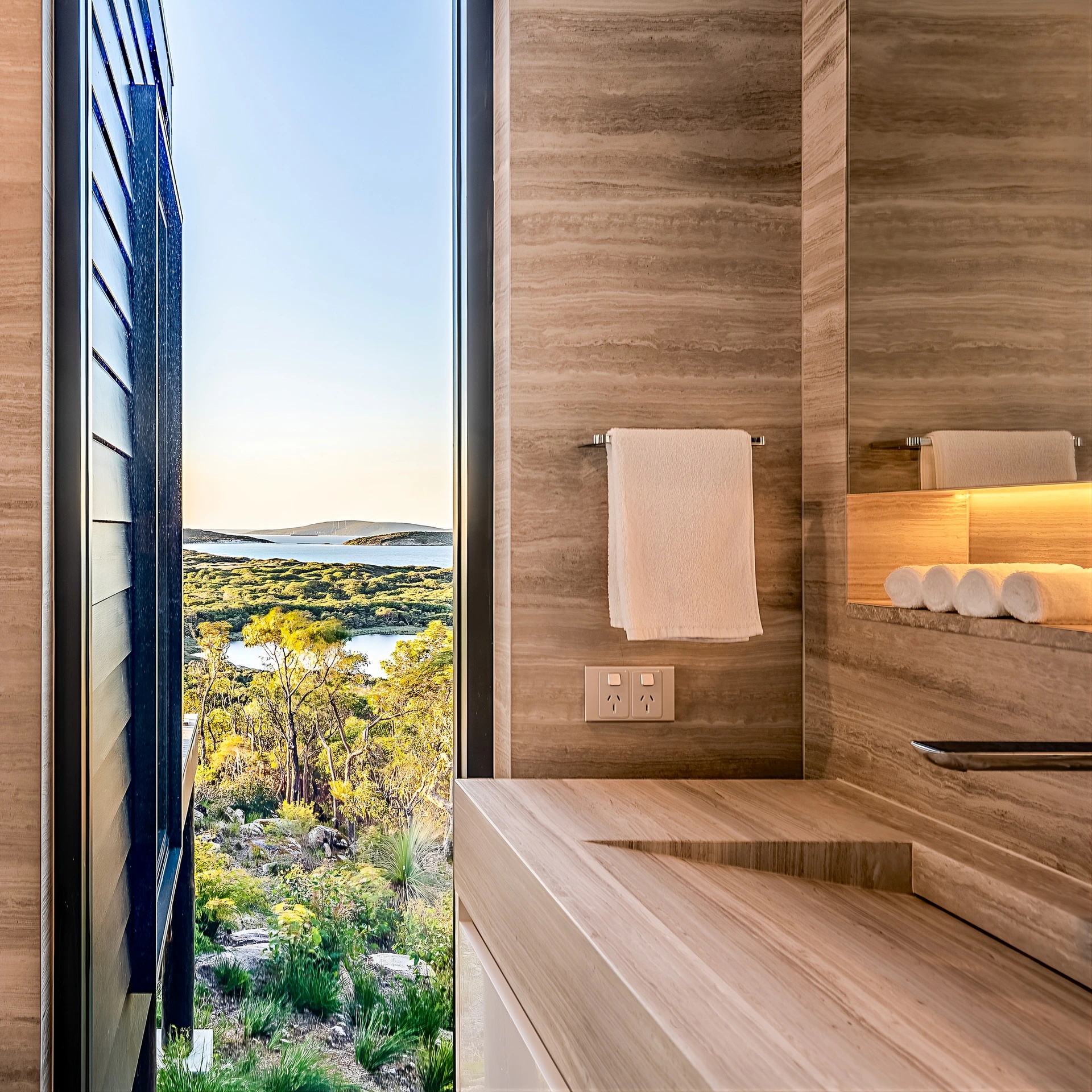 Modern bathroom interior featuring marble sink and scenic outdoor view