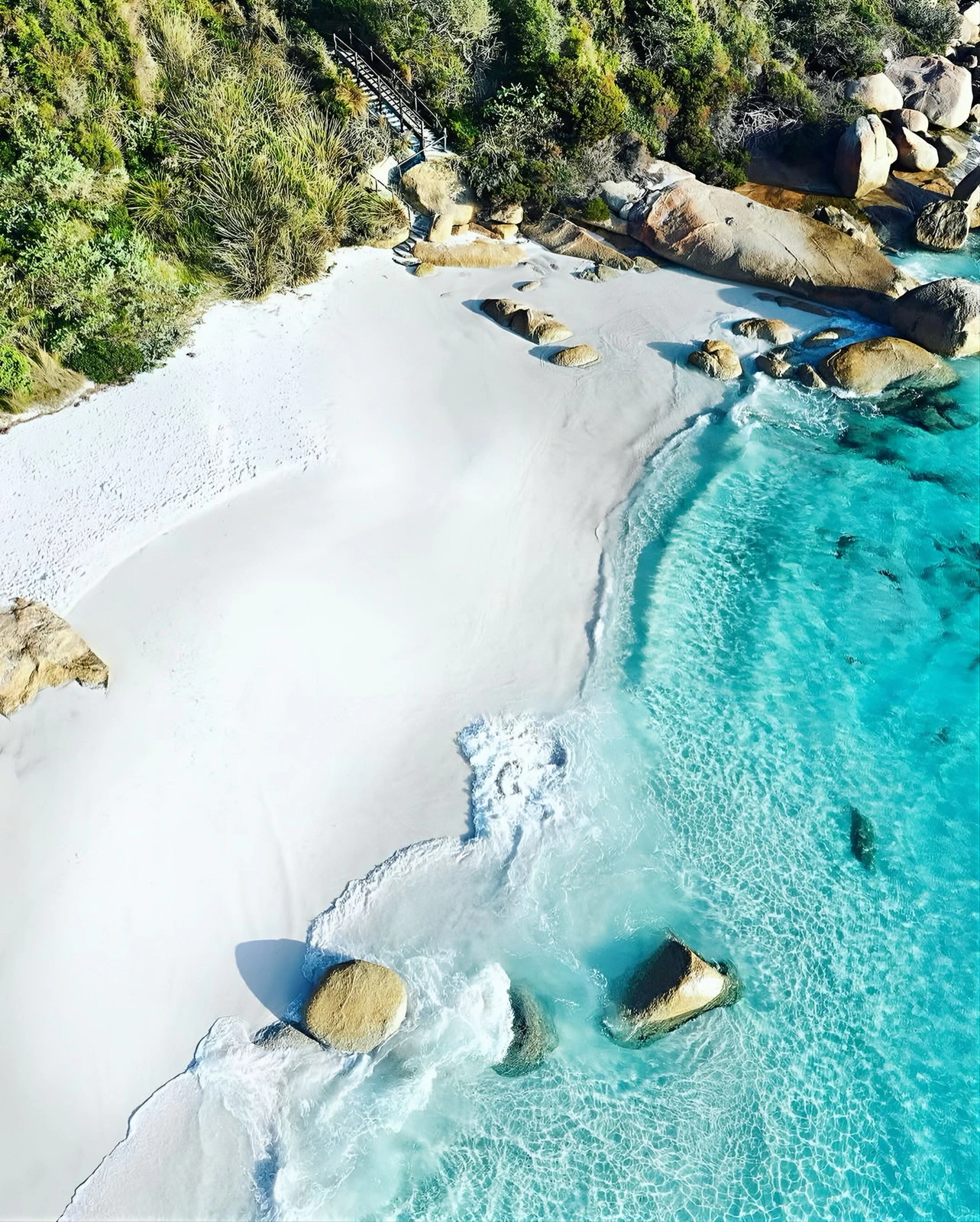 Aerial view of white sandy beach and clear turquoise water