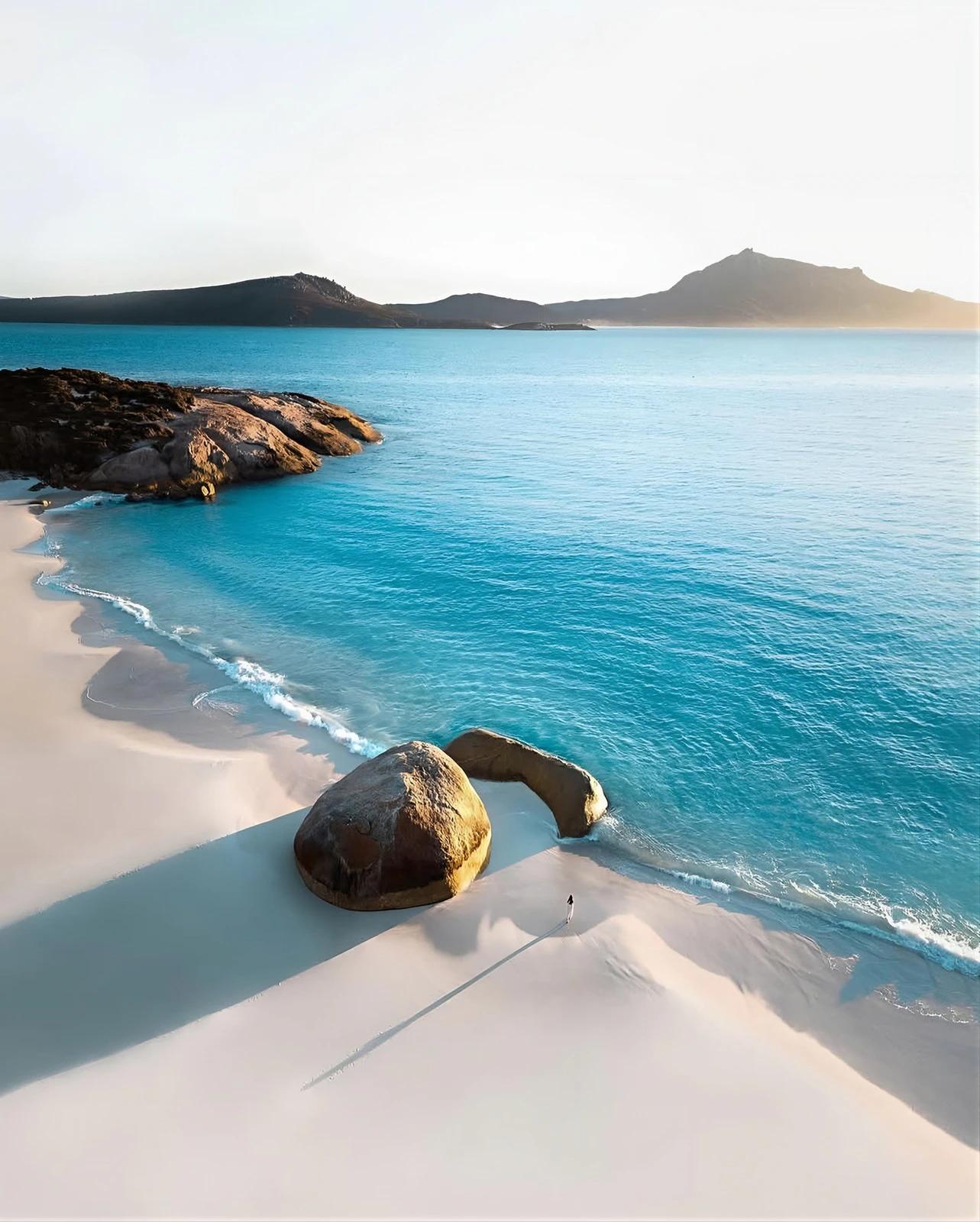 Aerial view of pristine beach and blue ocean coastline