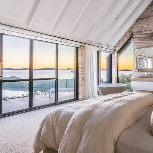Bedroom interior overlooking ocean sunset view