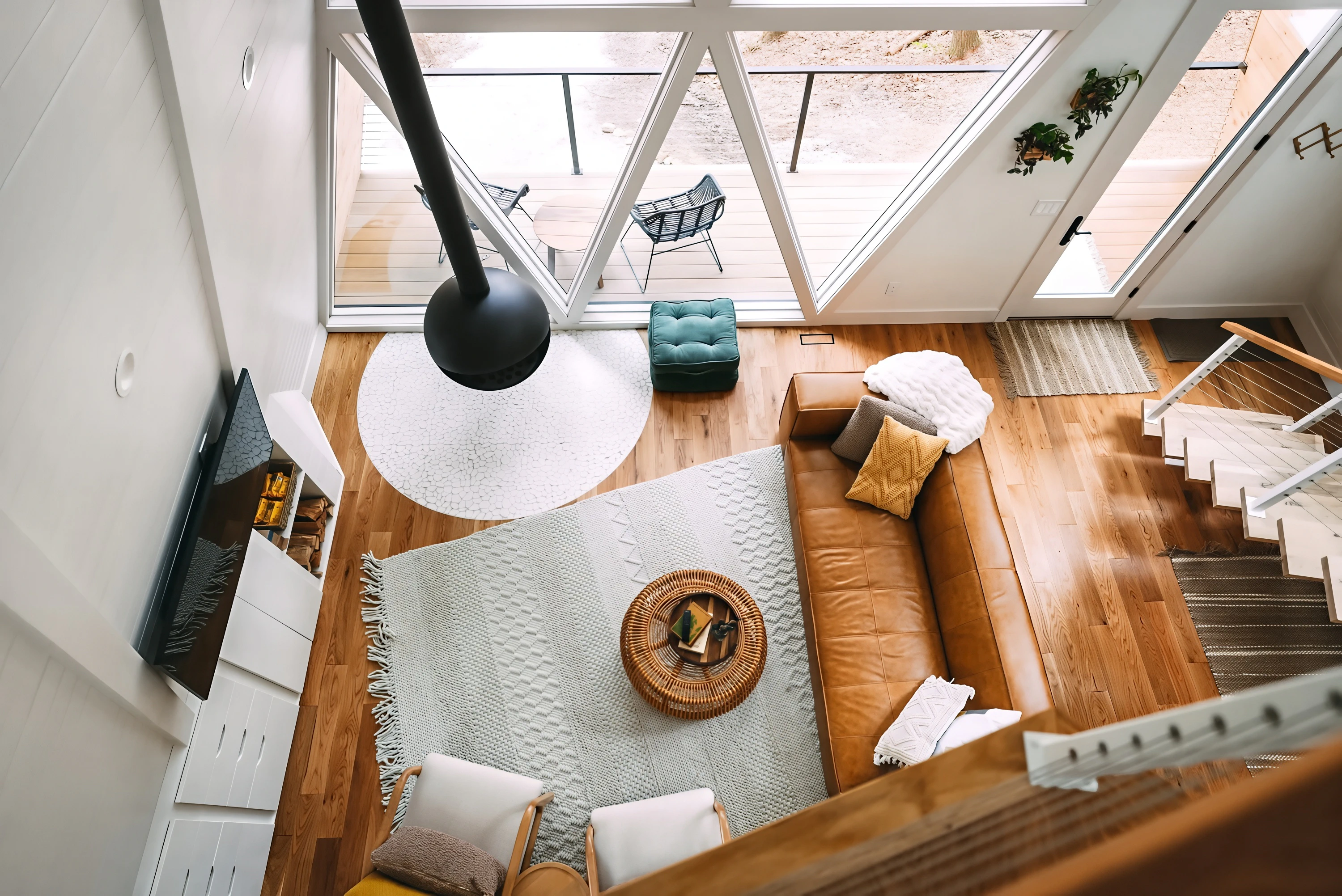 A-frame living room interior with timber flooring and large windows